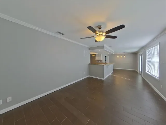 an empty room with closet and ceiling fan