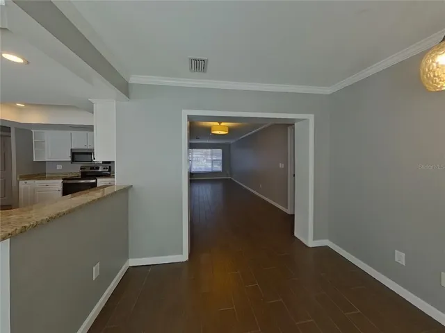 a view of a kitchen from the hallway
