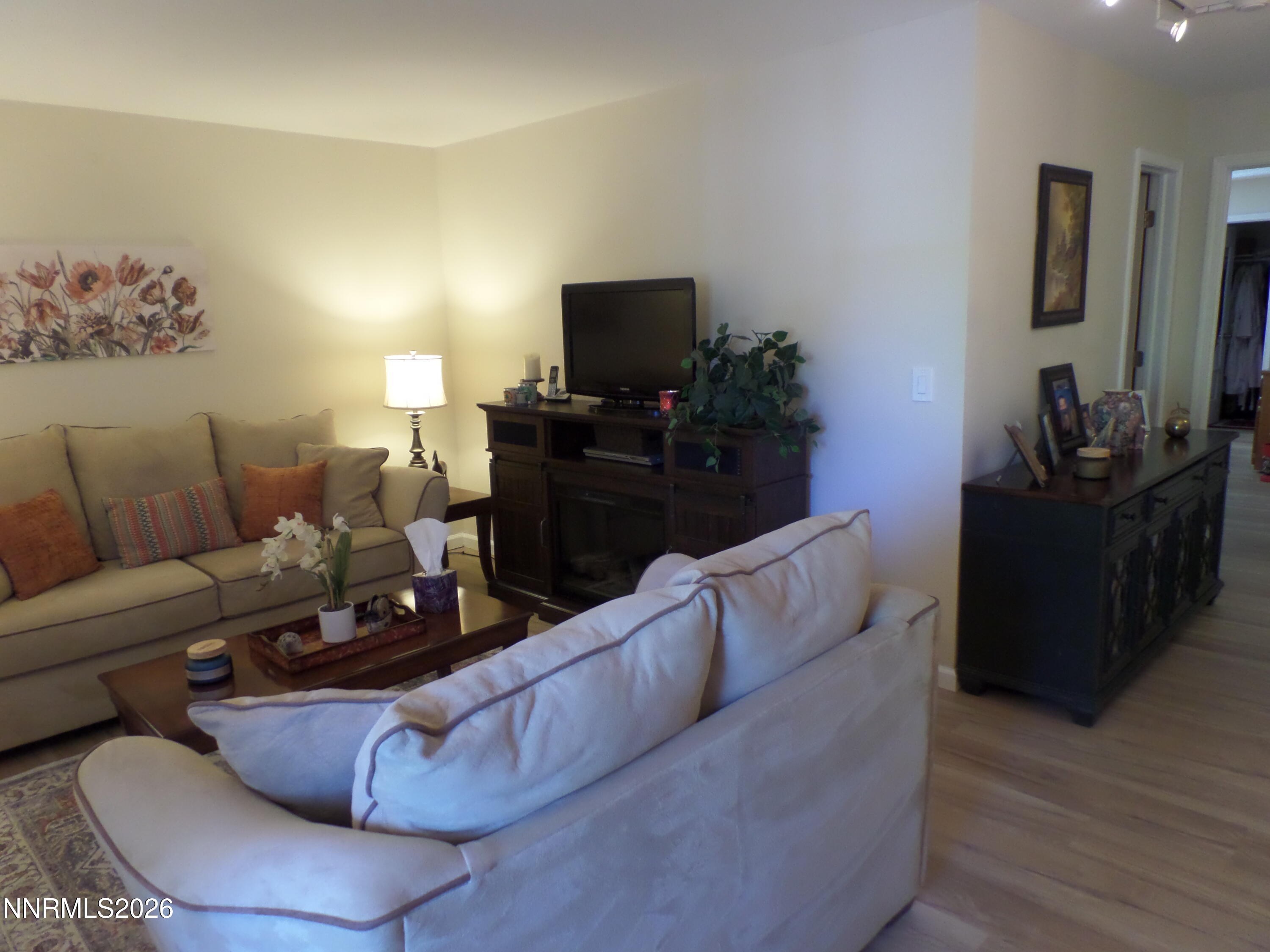3890 East Leonesio Drive, Unit D1 Reno, NV 89512 - Photo 13 of 32 a living room with furniture and a flat screen tv
