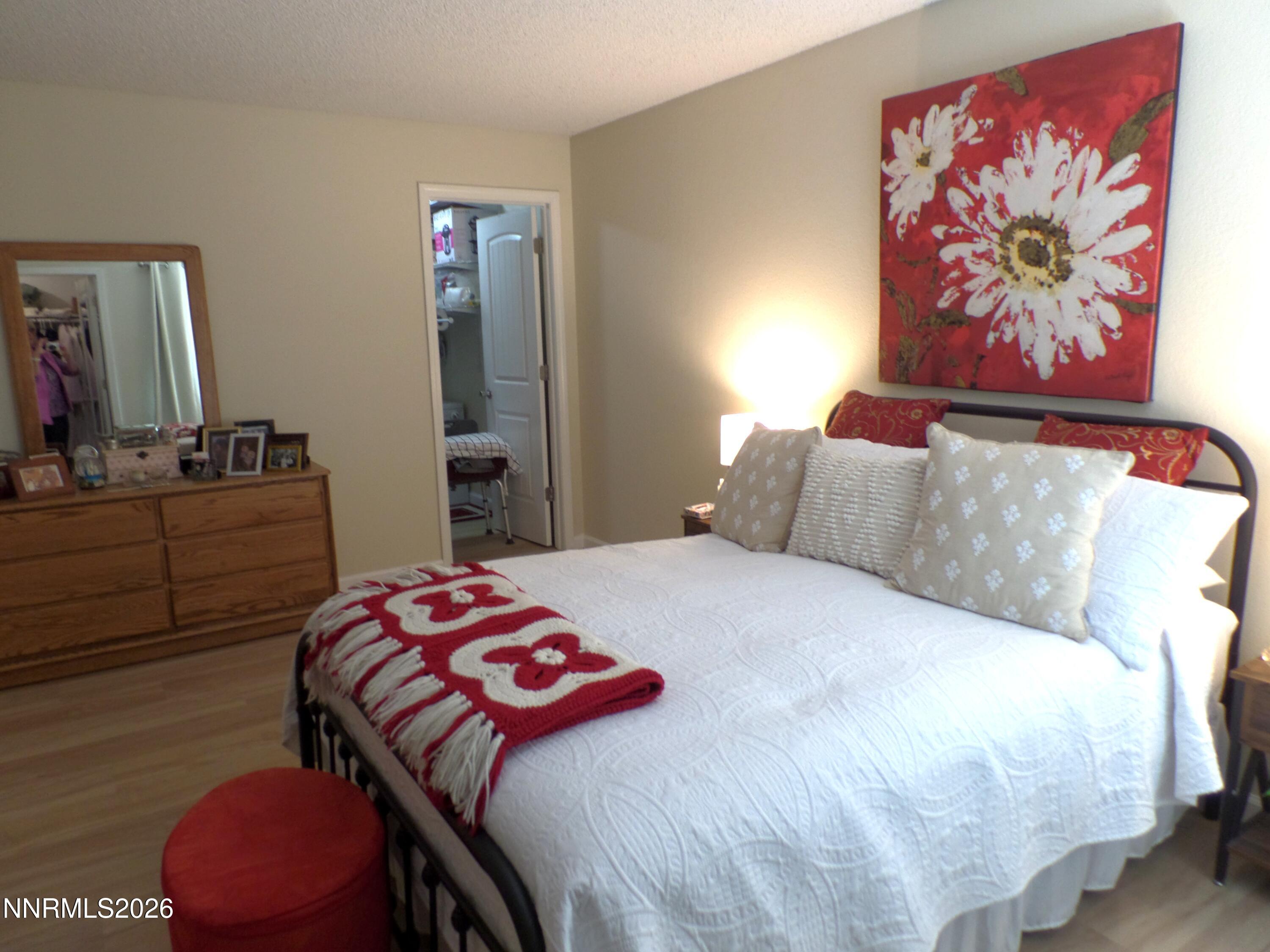 3890 East Leonesio Drive, Unit D1 Reno, NV 89512 - Photo 15 of 32 a bedroom with a bed and dresser