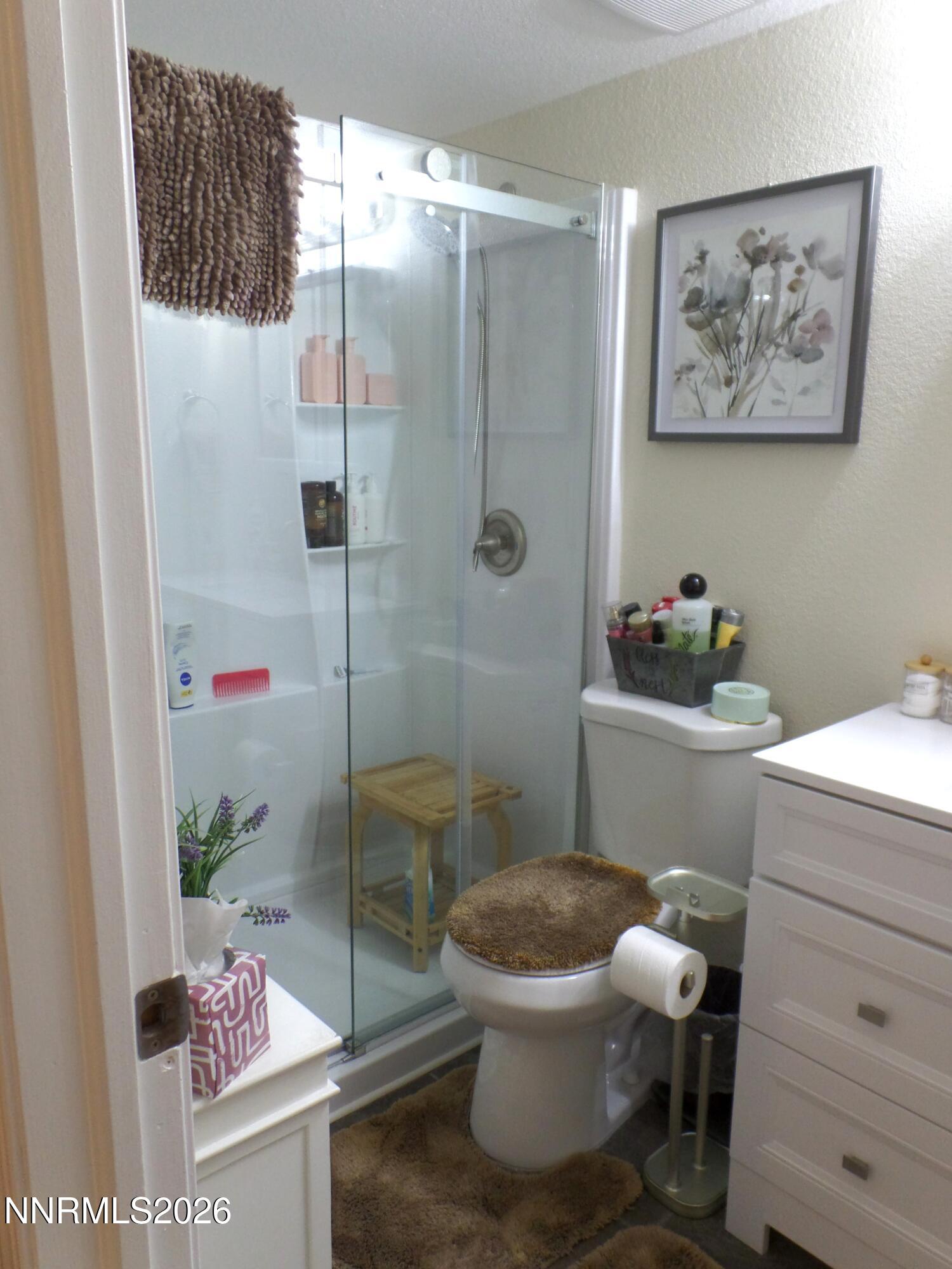 3890 East Leonesio Drive, Unit D1 Reno, NV 89512 - Photo 20 of 32 a bathroom with a toilet and a shower