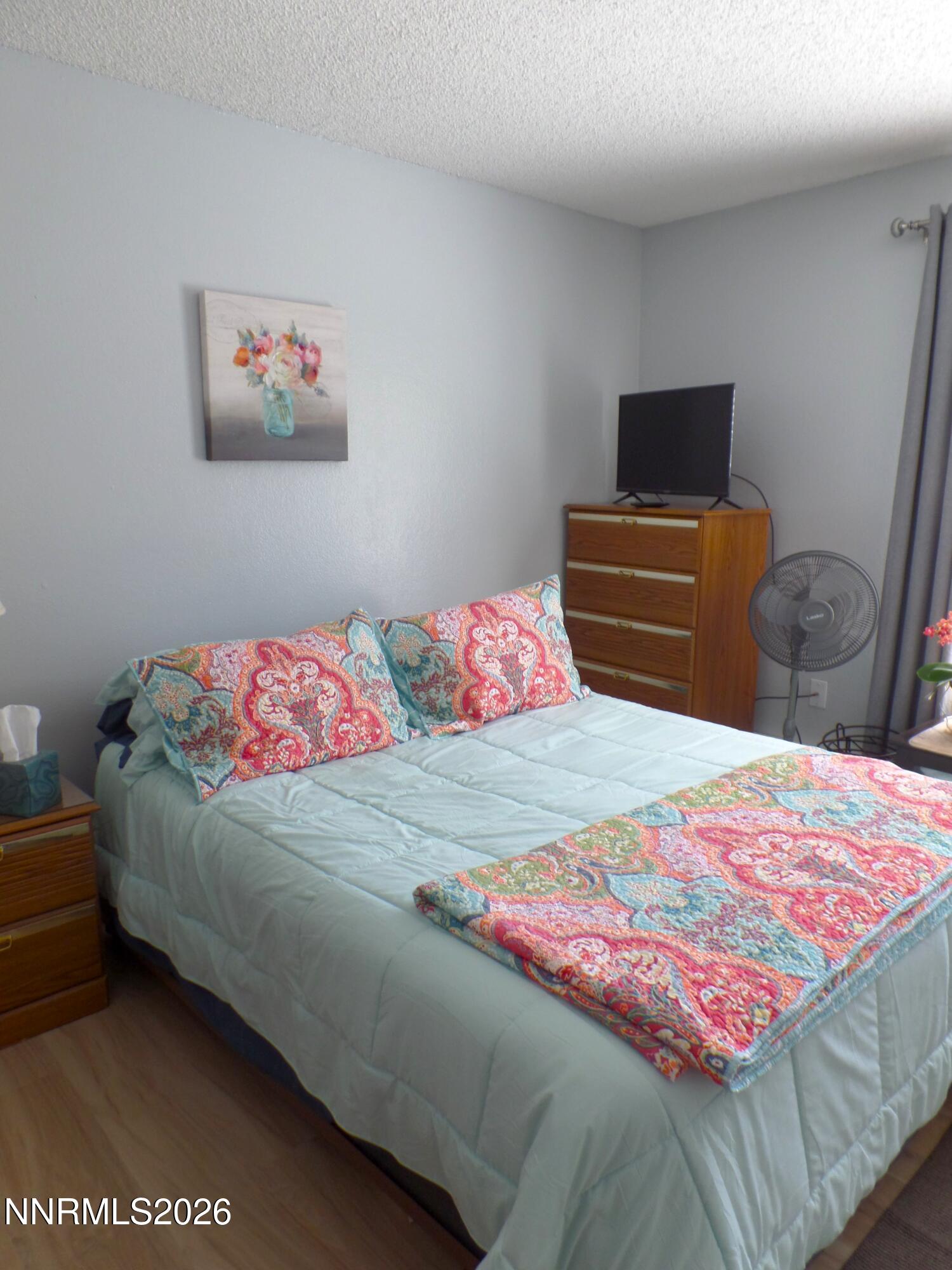 3890 East Leonesio Drive, Unit D1 Reno, NV 89512 - Photo 22 of 32 a bedroom with a bed and dresser