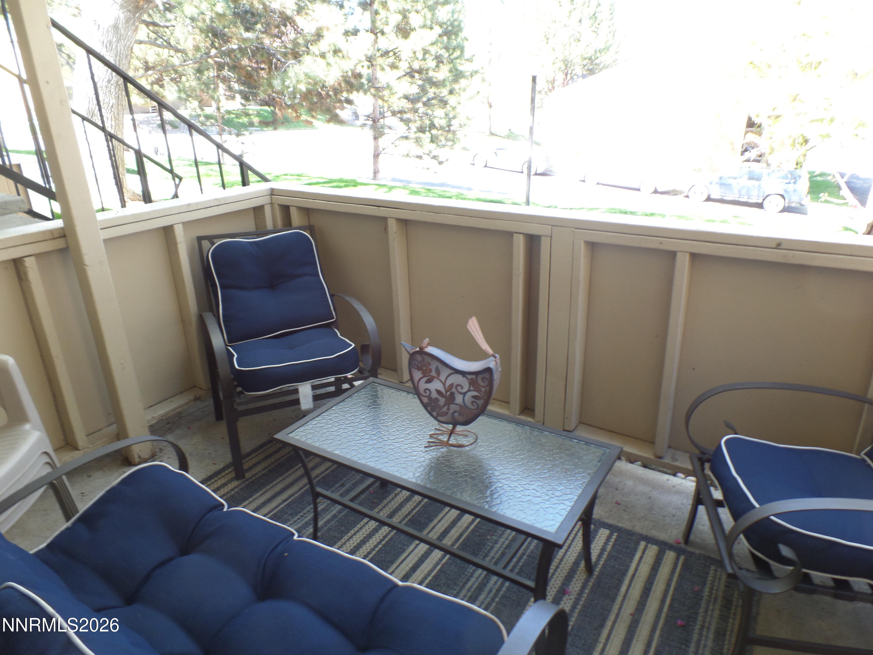3890 East Leonesio Drive, Unit D1 Reno, NV 89512 - Photo 24 of 32 a view of a balcony with chair and table