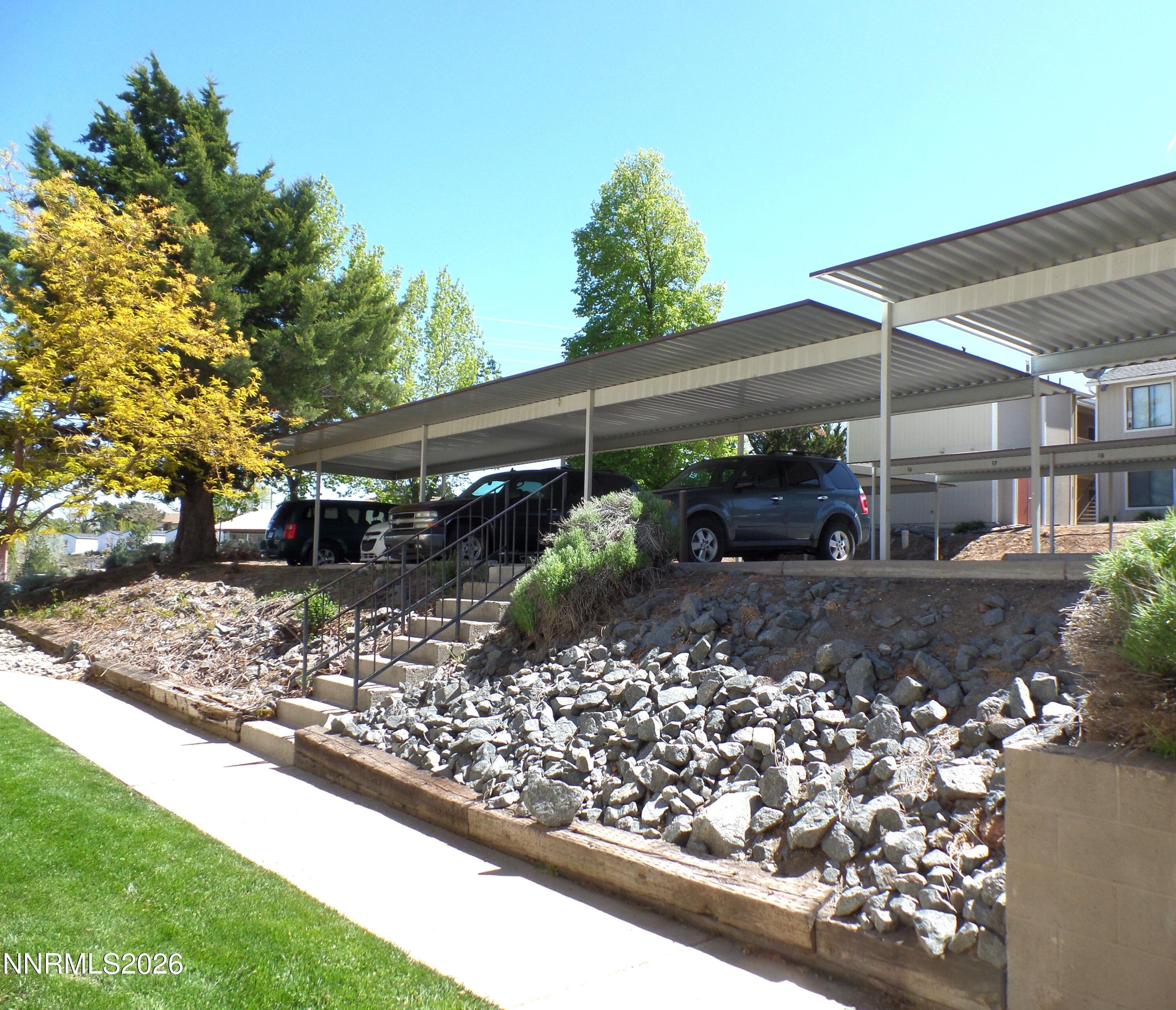 3890 East Leonesio Drive, Unit D1 Reno, NV 89512 - Photo 29 of 32 a view of a backyard with plants and large trees