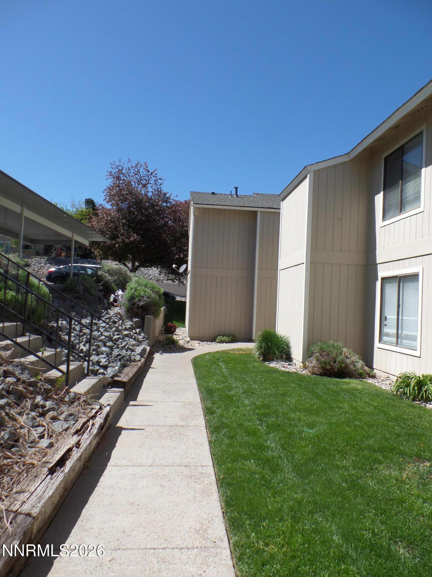 3890 East Leonesio Drive, Unit D1 Reno, NV 89512 - Photo 30 of 32 a view of house with backyard and garden