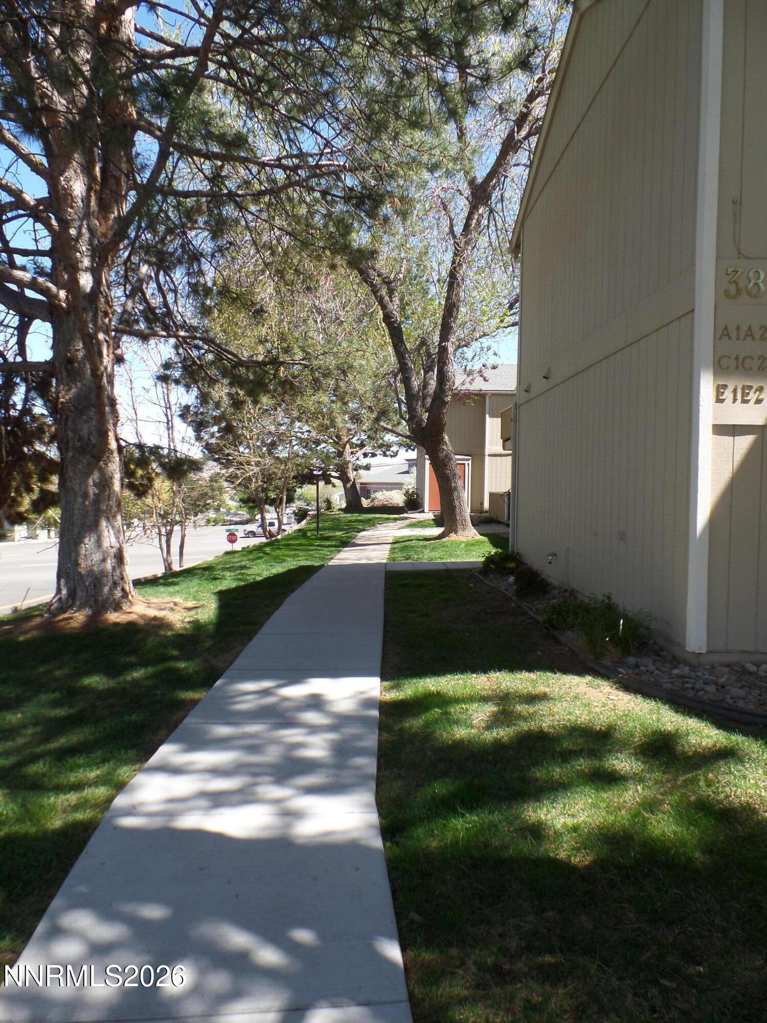 3890 East Leonesio Drive, Unit D1 Reno, NV 89512 - Photo 31 of 32 a view of a street with a yard and trees