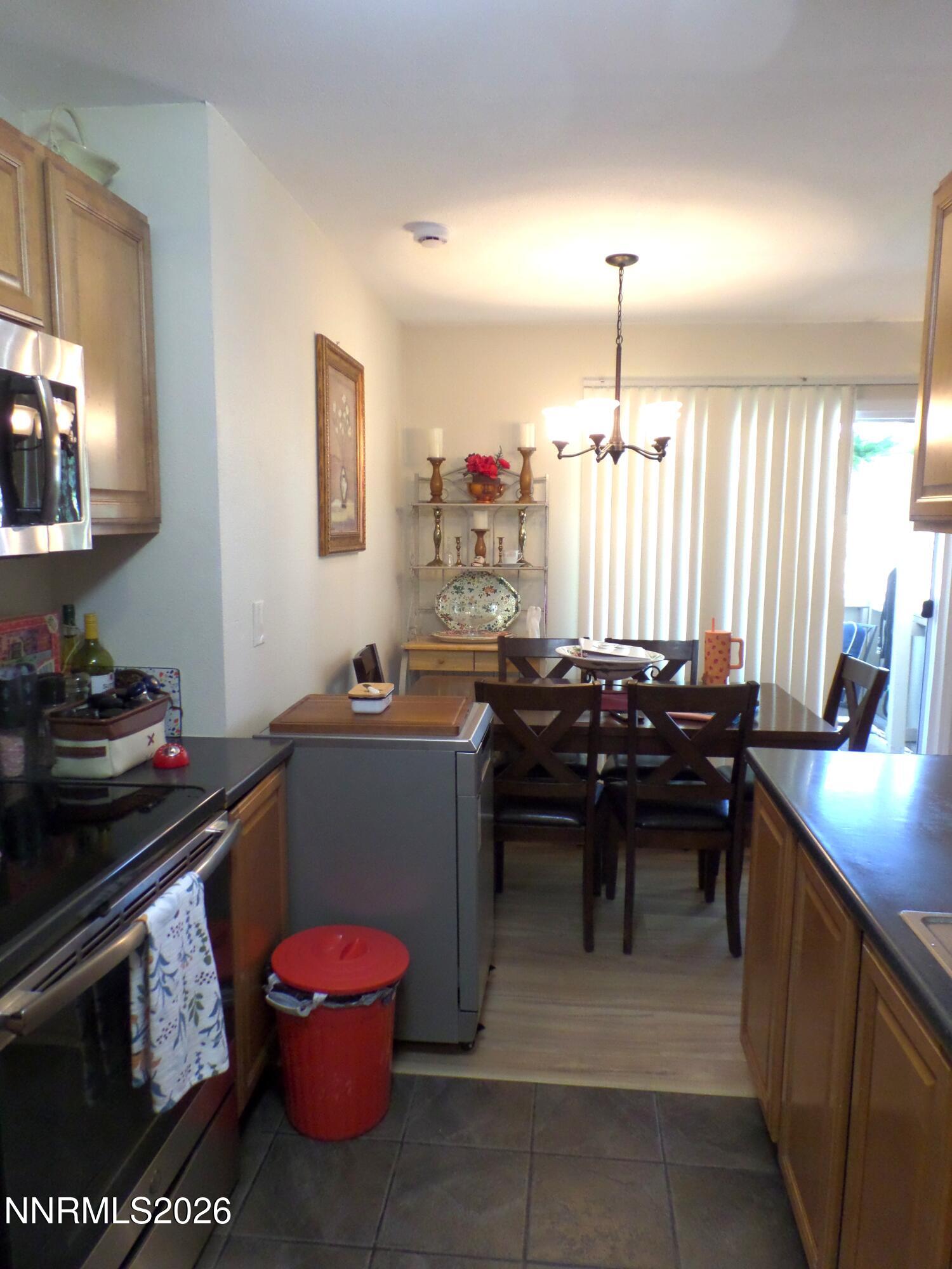 3890 East Leonesio Drive, Unit D1 Reno, NV 89512 - Photo 4 of 32 a kitchen with a sink stove and cabinets