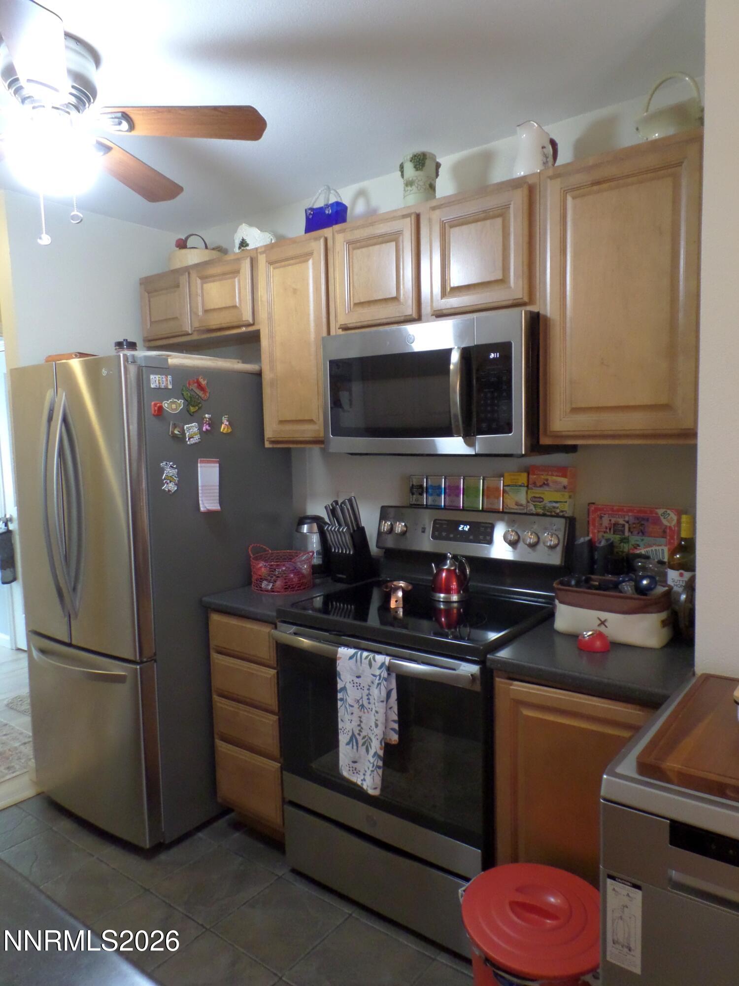 3890 East Leonesio Drive, Unit D1 Reno, NV 89512 - Photo 6 of 32 a kitchen with a refrigerator stove and microwave