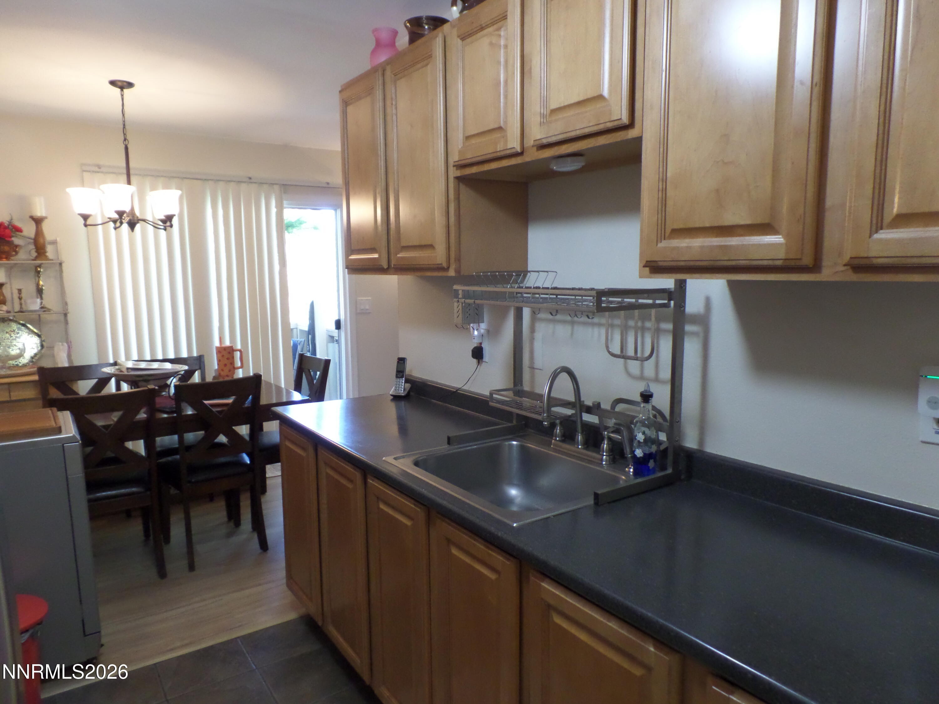 3890 East Leonesio Drive, Unit D1 Reno, NV 89512 - Photo 8 of 32 a kitchen with a sink and cabinets