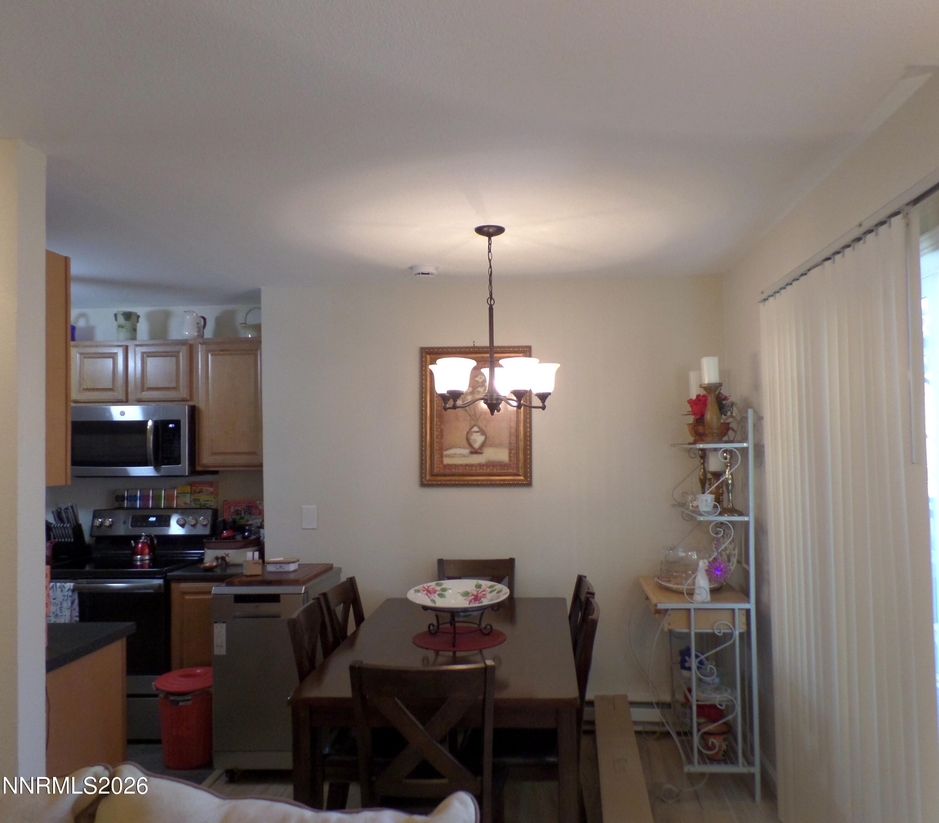 3890 East Leonesio Drive, Unit D1 Reno, NV 89512 - Photo 9 of 32 a kitchen with a dining table and chairs