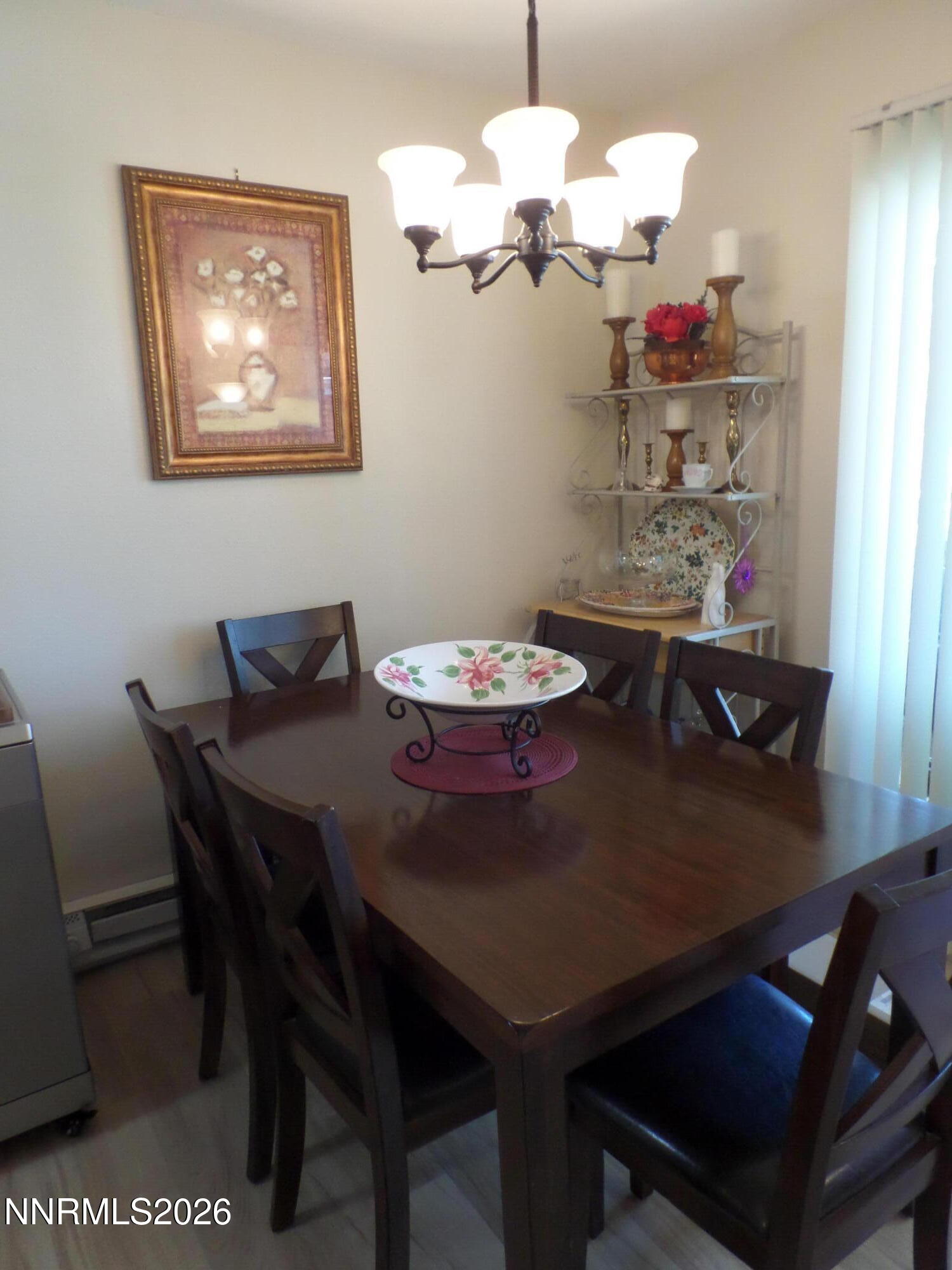 3890 East Leonesio Drive, Unit D1 Reno, NV 89512 - Photo 10 of 32 a view of a dining room with furniture and chandelier