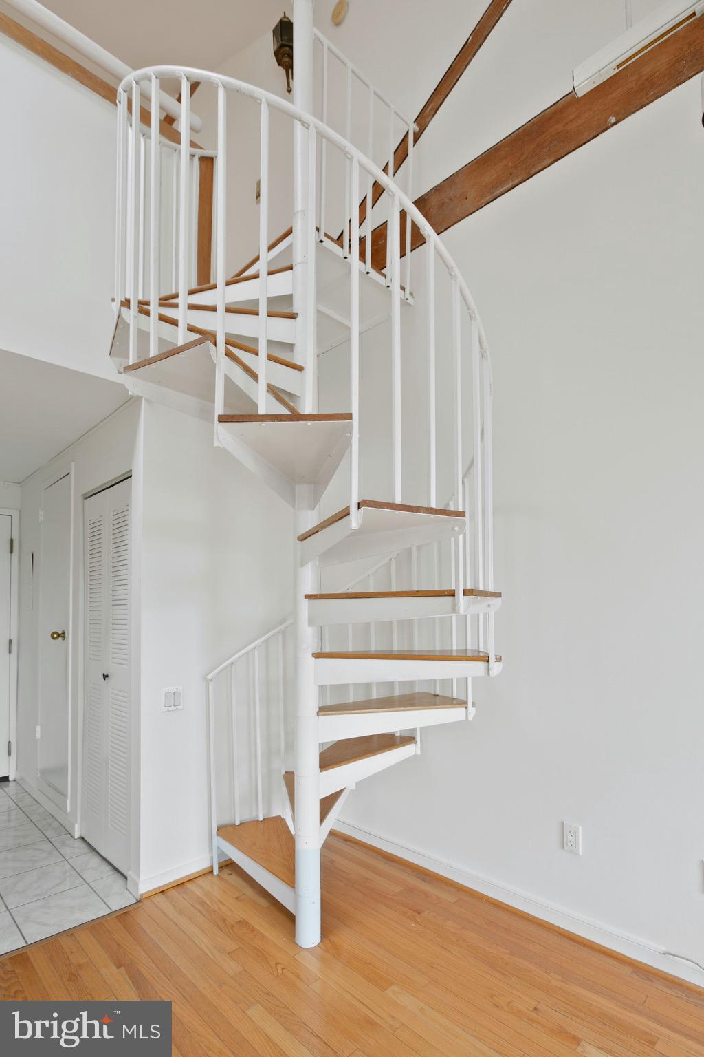 2639 Boston Street, Unit 313 Baltimore, MD 21224 - Photo 6 of 33 spiral staircase leading to the second floor
