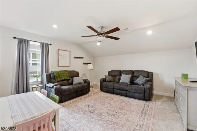 a bedroom with a bed and a ceiling fan