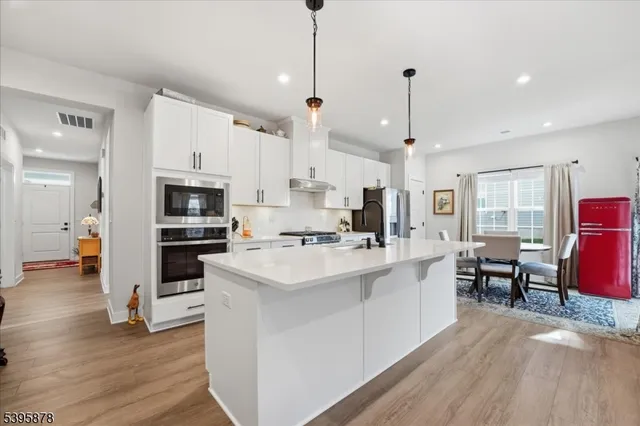 a kitchen with a dining table and refrigerator