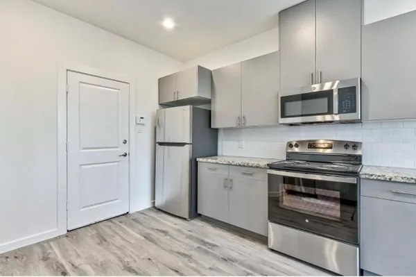 a kitchen with a stove and a microwave