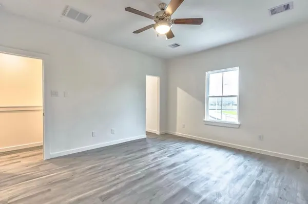 wooden floor in an empty room with a window