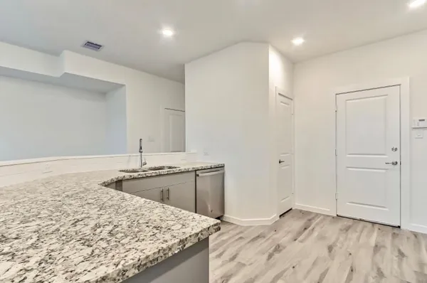 a bathroom with a granite countertop sink and a wooden cabinets