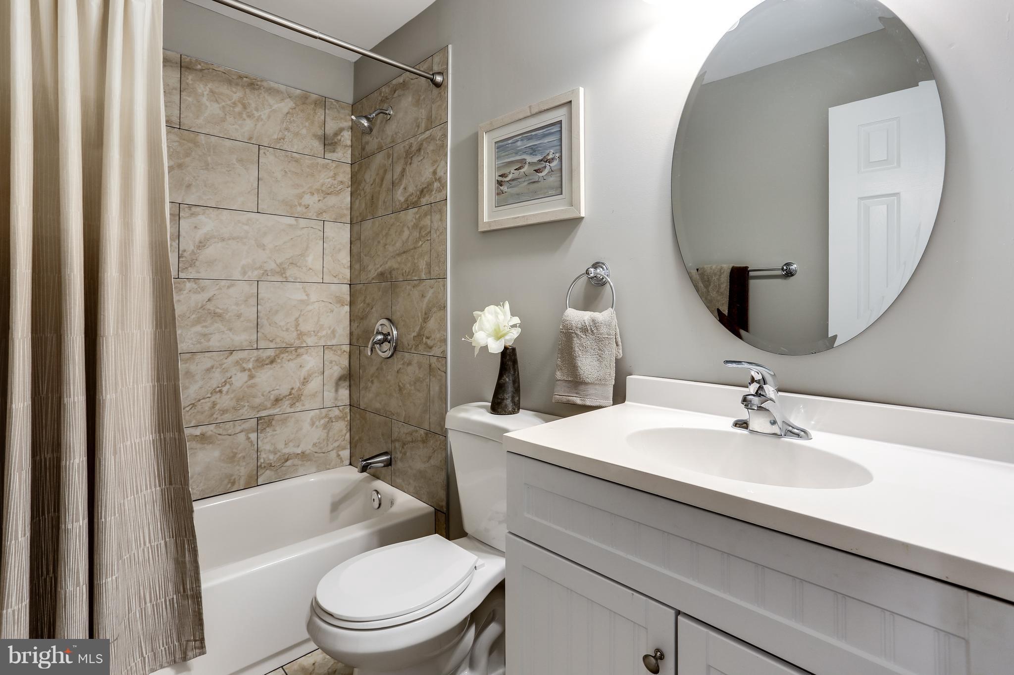 1700 Quantico Road Edgewater, MD 21037 - Photo 11 of 25 a bathroom with a sink a toilet and shower