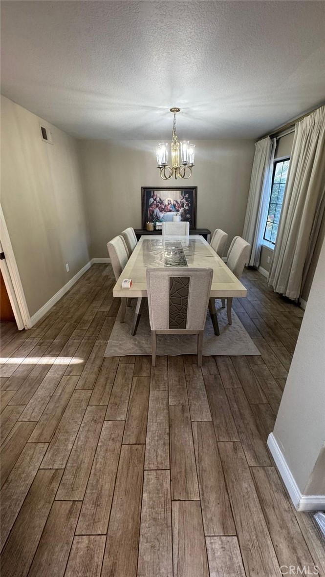 25 Morning Breeze, Unit 46 Irvine, CA 92603 - Photo 11 of 26 a view of a livingroom with furniture wooden floor and chandelier