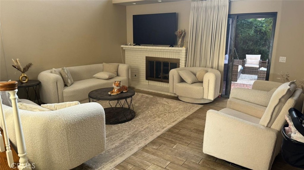 25 Morning Breeze, Unit 46 Irvine, CA 92603 - Photo 18 of 26 a living room with furniture a fireplace and a flat screen tv