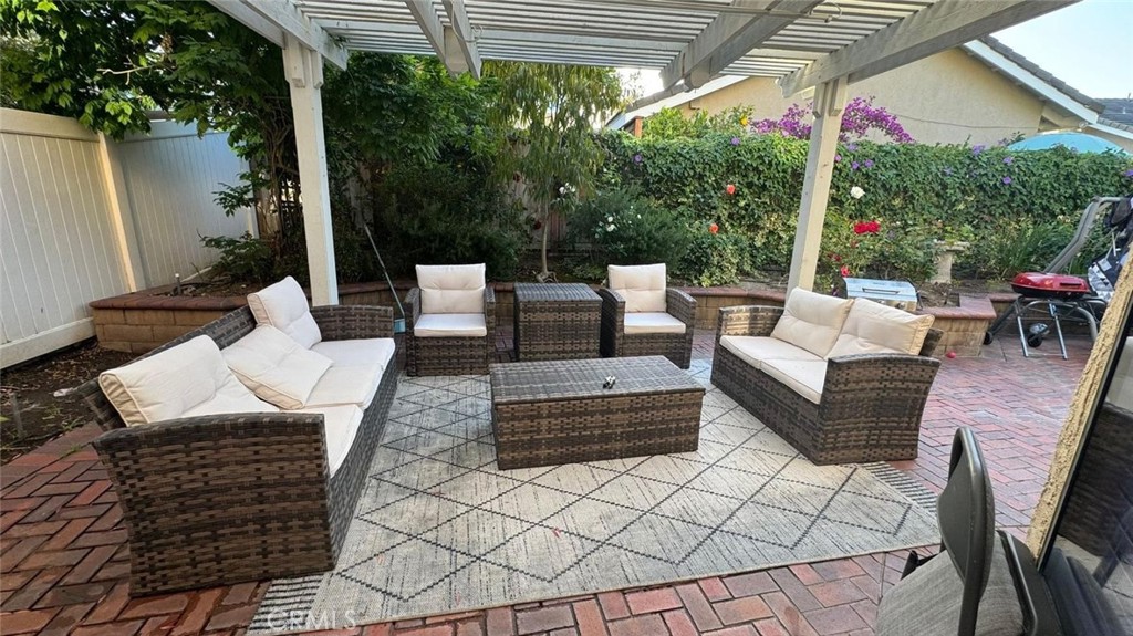 25 Morning Breeze, Unit 46 Irvine, CA 92603 - Photo 3 of 26 a view of a patio with couches table and chairs and potted plants