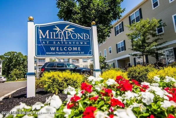 a sign that is in front of flowers