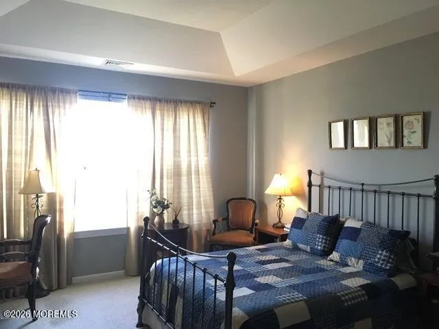 a bedroom with furniture and a window