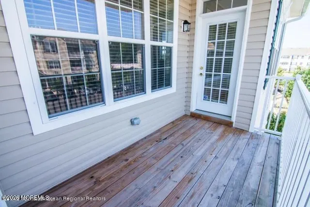 a view of front door with wooden floor and a window