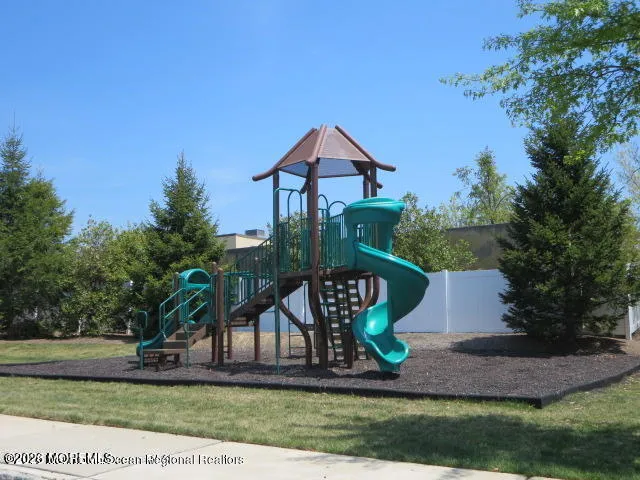 a view of a table and chairs under an umbrella