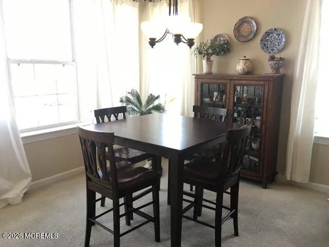 a view of a dining room with furniture and window
