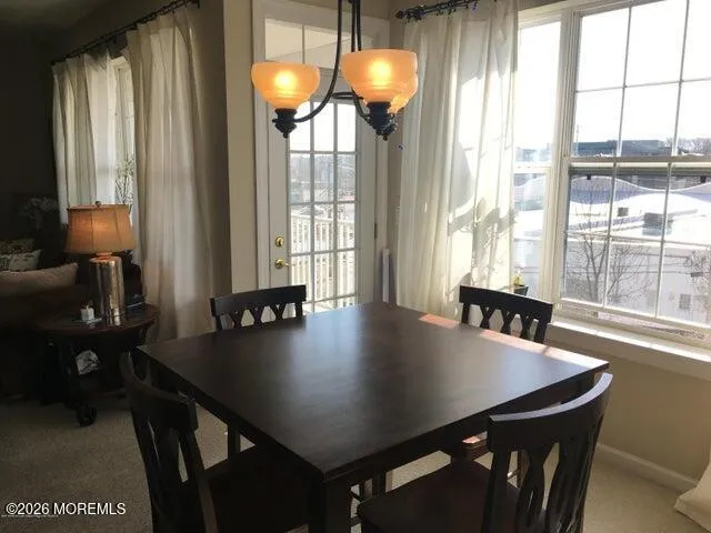 a view of a dining room with furniture and window