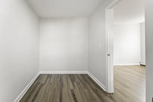 a view of a room with wooden floor