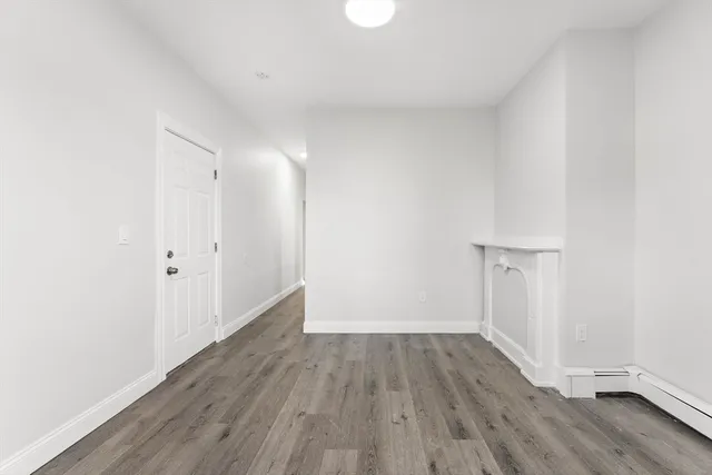 a view of a room with wooden floor