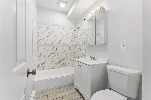 a bathroom with a sink toilet and shower