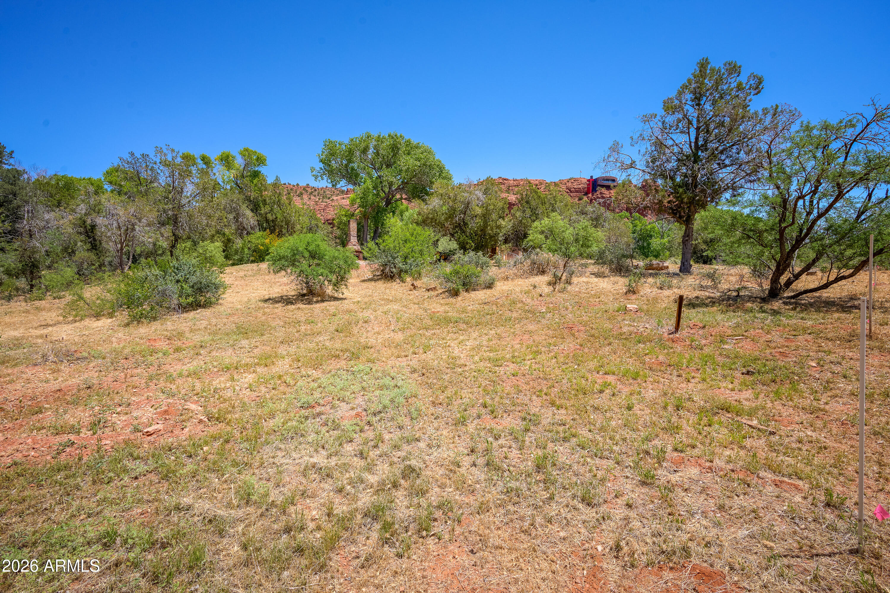 3155 Red Rock Loop Road, Unit 2 Sedona, AZ 86336 - Photo 11 of 22 a backyard of a house with lots of green space