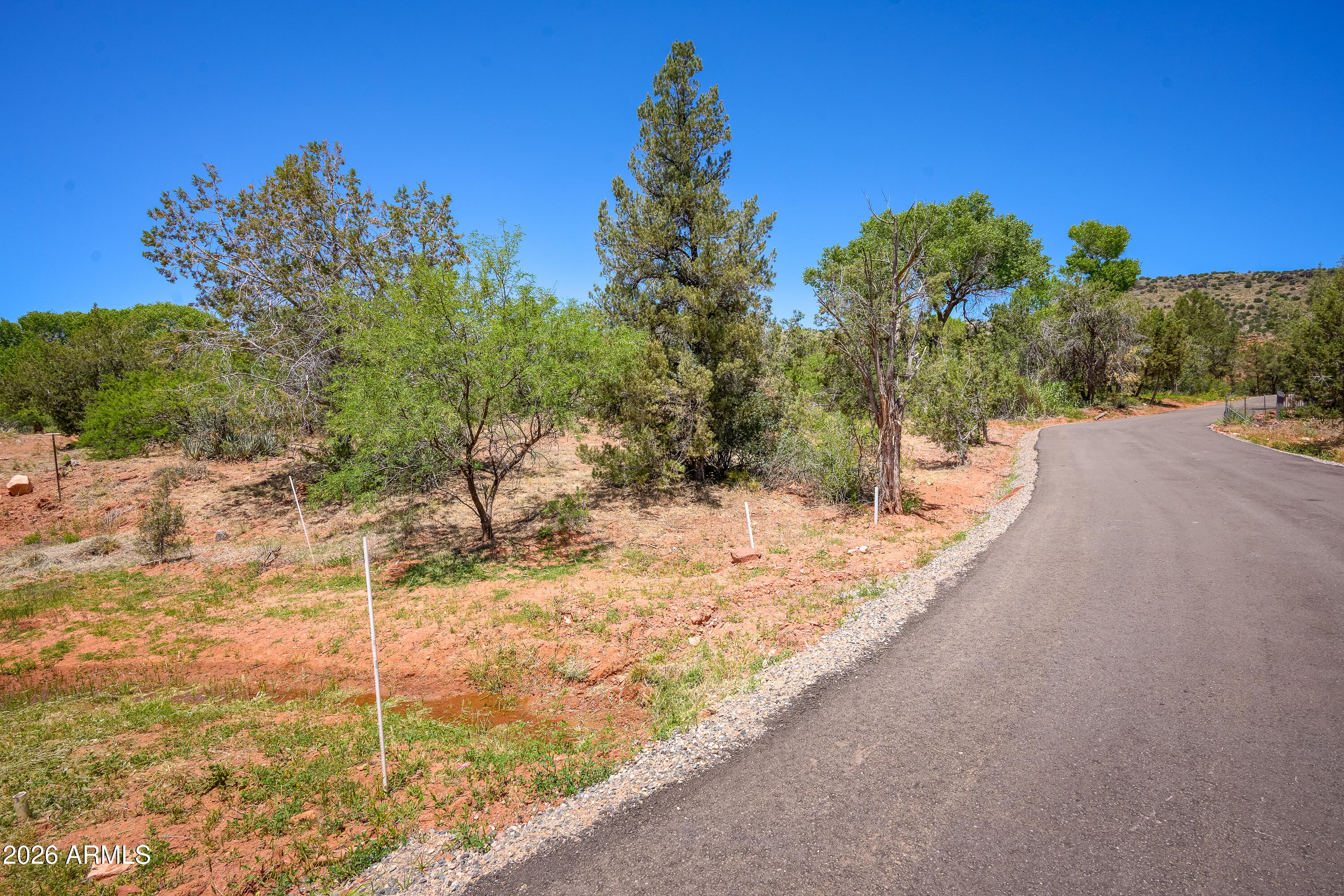 3155 Red Rock Loop Road, Unit 2 Sedona, AZ 86336 - Photo 12 of 22 a view of a yard along with trees
