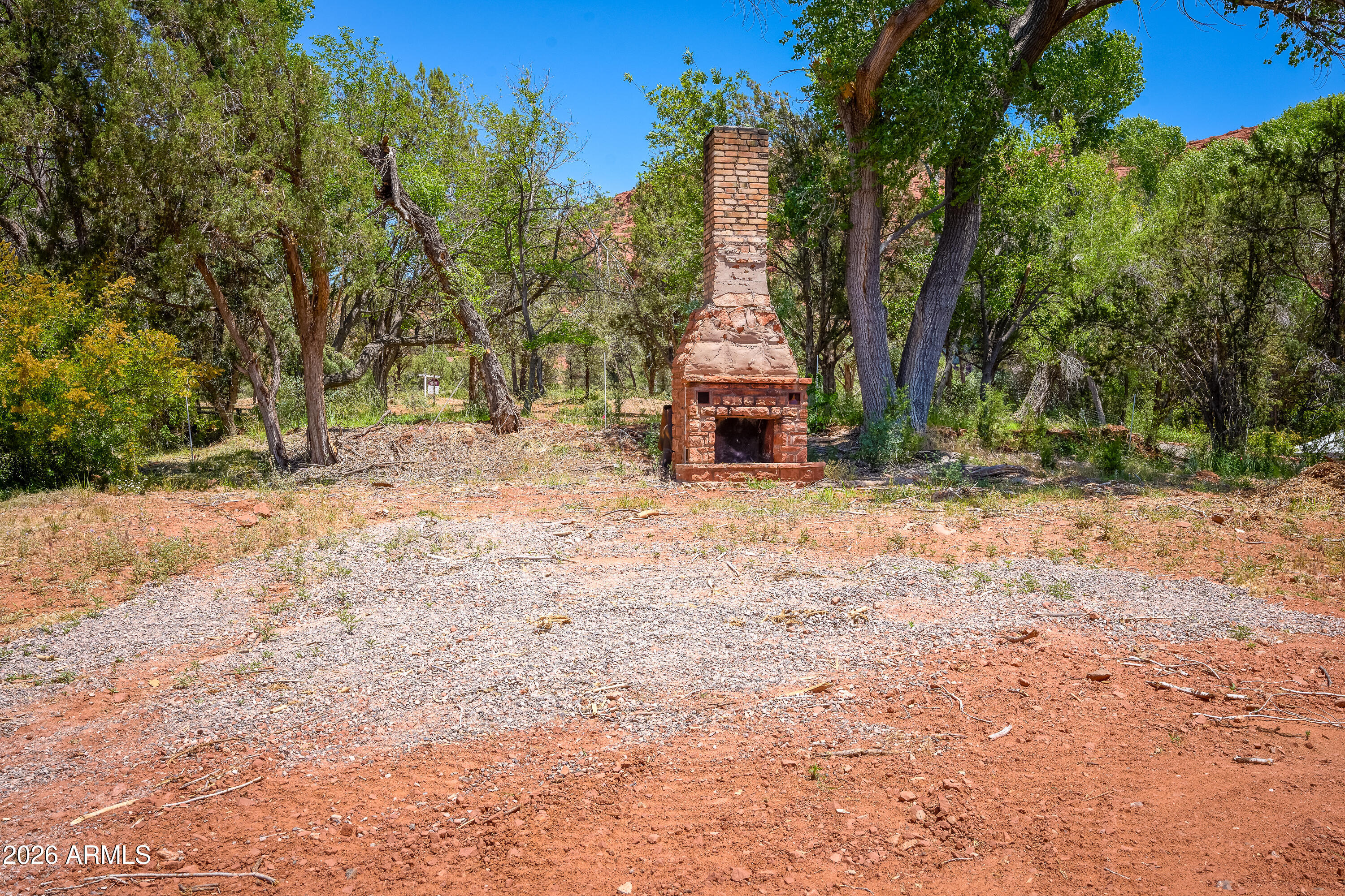 3155 Red Rock Loop Road, Unit 2 Sedona, AZ 86336 - Photo 15 of 22 a view of a backyard with large trees