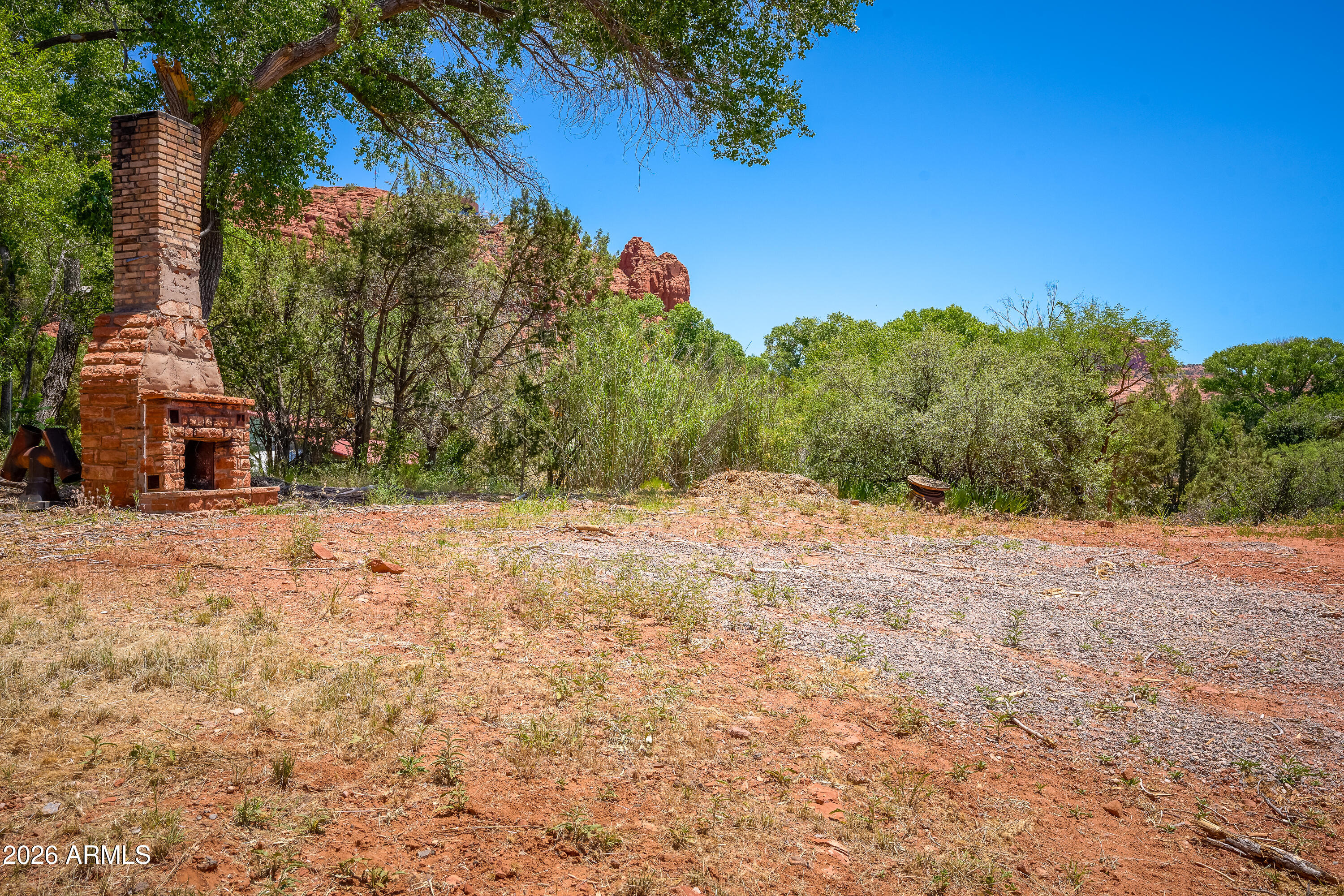 3155 Red Rock Loop Road, Unit 2 Sedona, AZ 86336 - Photo 21 of 22 a backyard of a house with lots of green space