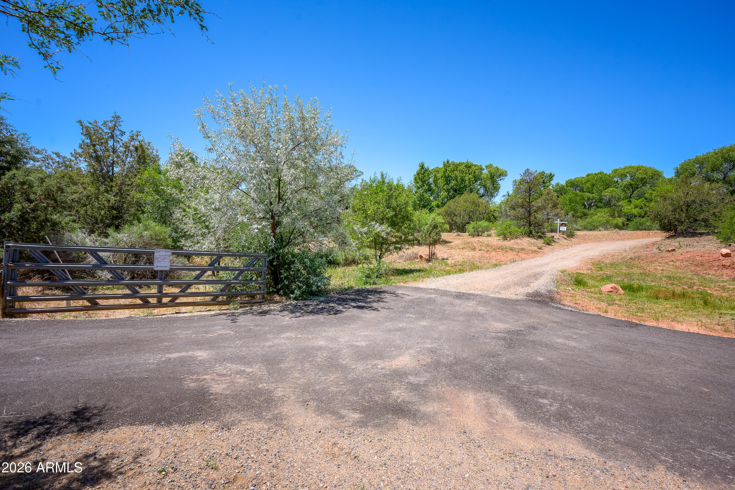 3155 Red Rock Loop Road, Unit 2 Sedona, AZ 86336 - Photo 8 of 22 a view of a street with some trees in the background