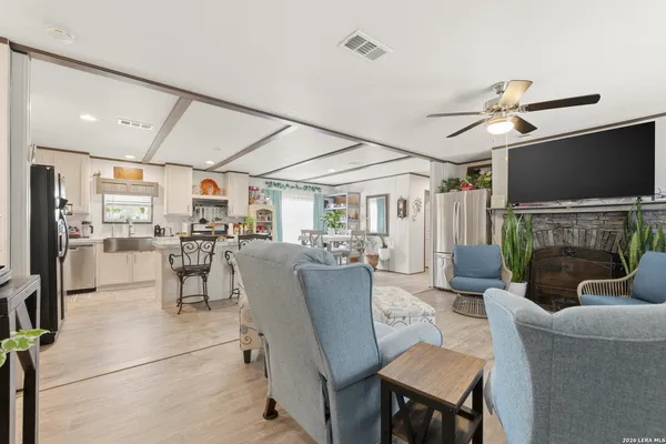 a dining room with furniture a flat screen tv and a fireplace