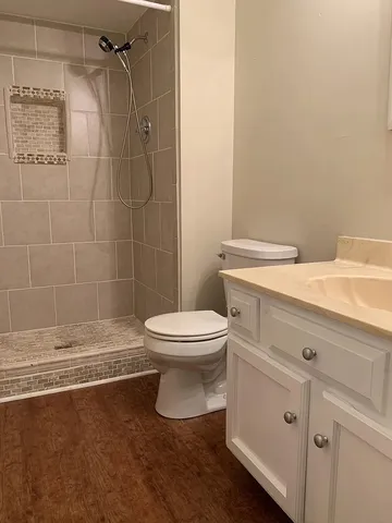 a bathroom with a toilet a sink and shower