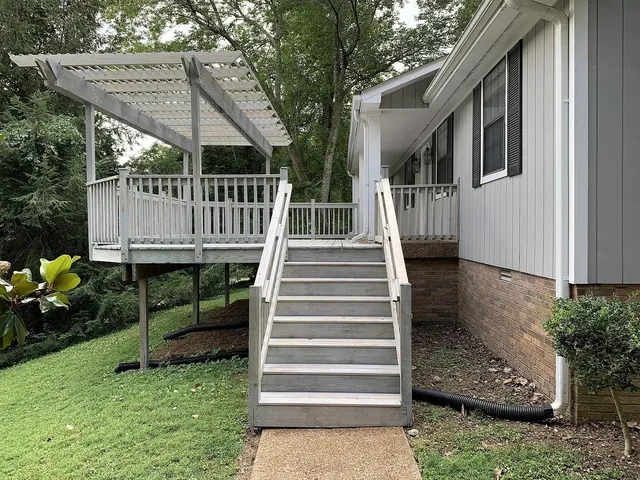 a view of patio with wooden deck and furniture