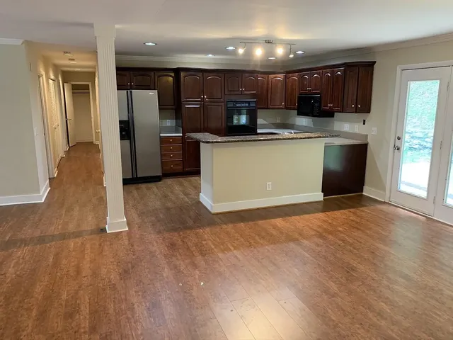 a kitchen with stainless steel appliances granite countertop a refrigerator sink and cabinets