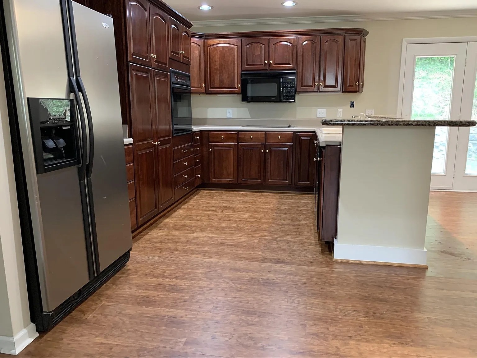 7420 Huntwick Trail Nashville, TN 37221 - Photo 6 of 19 a kitchen with stainless steel appliances granite countertop a refrigerator a sink and wooden cabinets
