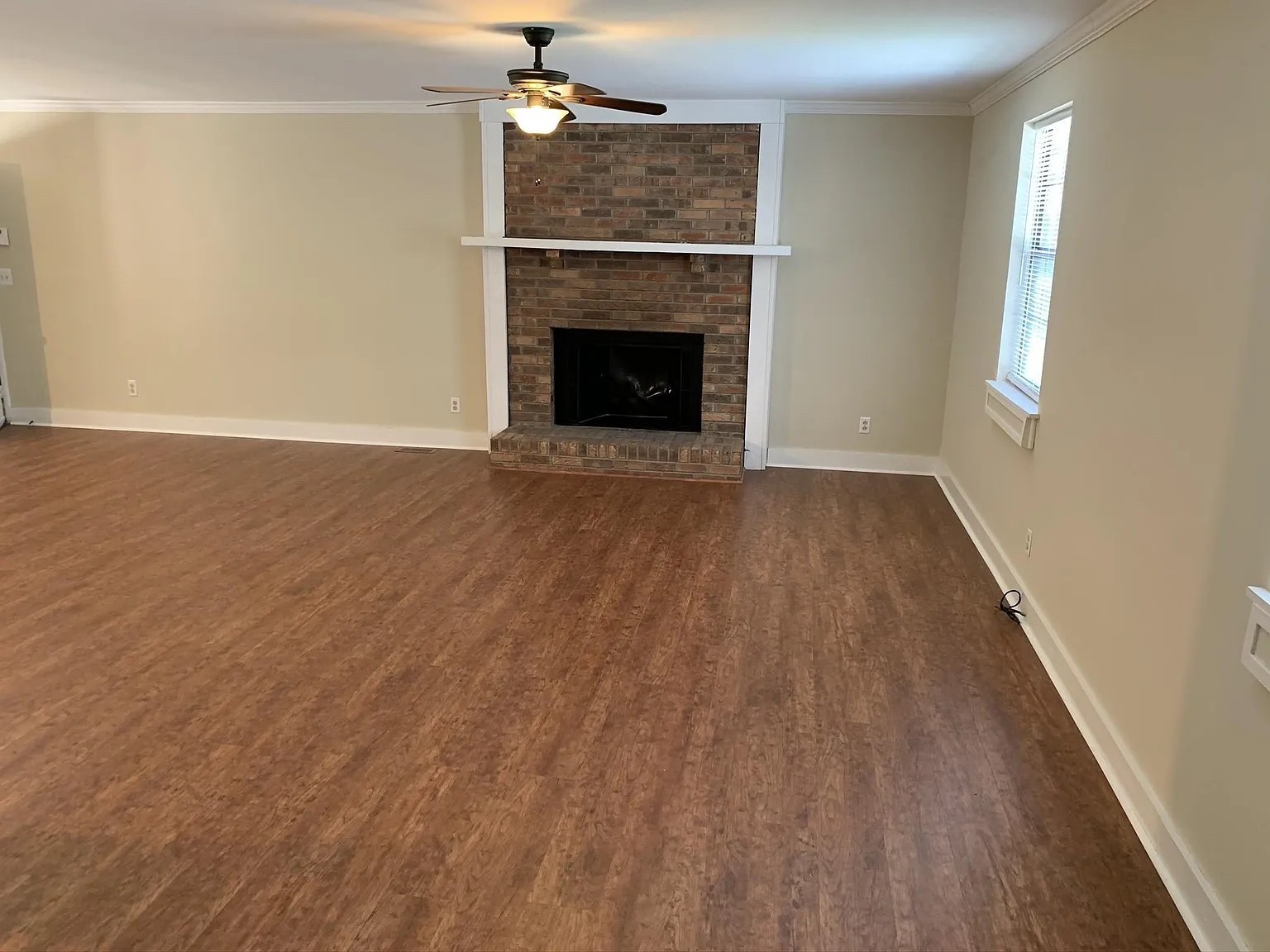 7420 Huntwick Trail Nashville, TN 37221 - Photo 8 of 19 an empty room with wooden floor fireplace and windows