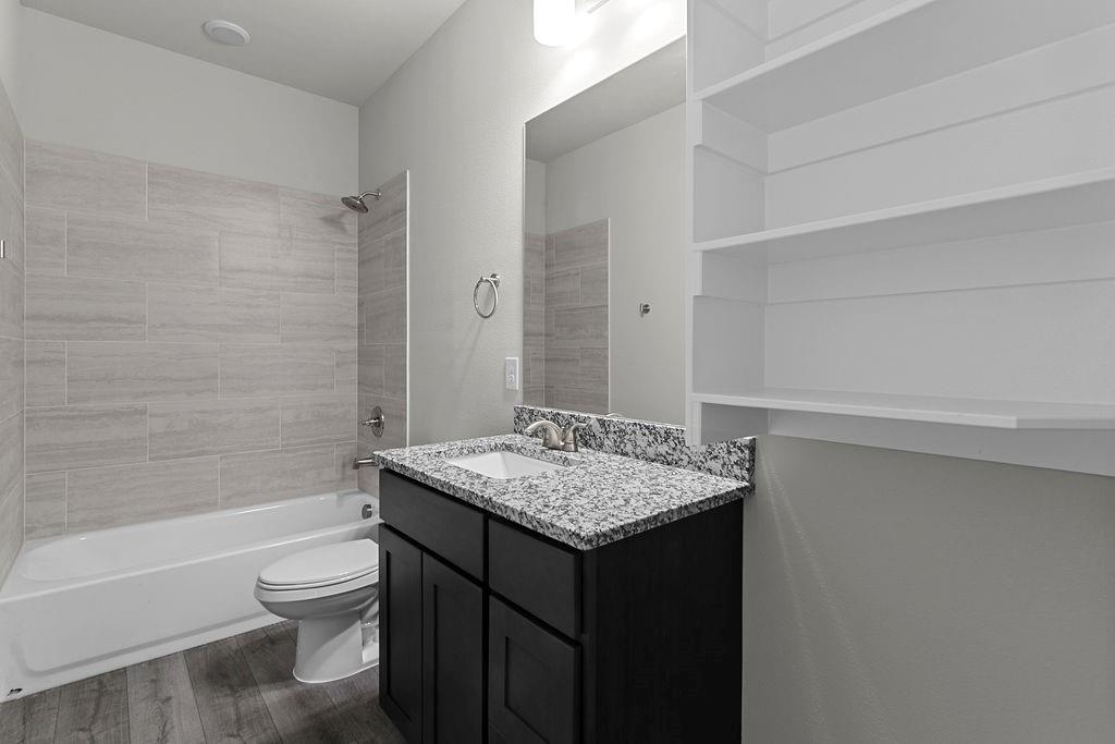 620 Alameda Road Azle, TX 76020 - Photo 25 of 27 a bathroom with a granite countertop sink toilet and shower