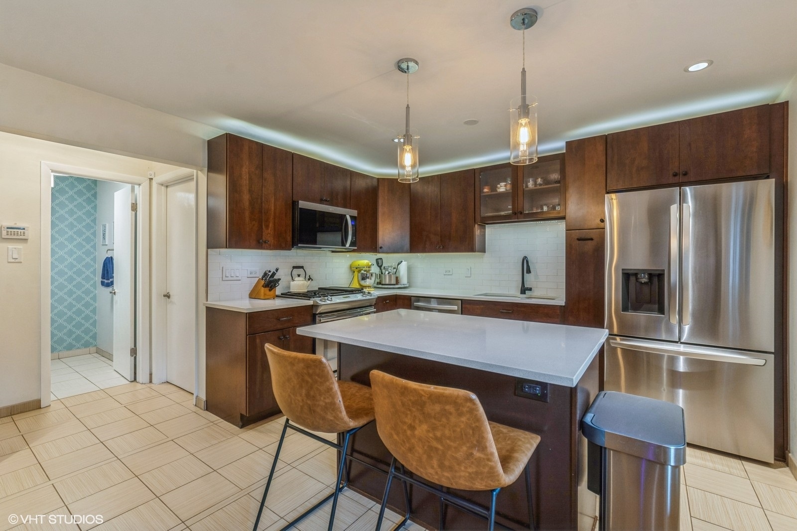 1045 West Altgeld Street, Unit A Chicago, IL 60614 - Photo 7 of 17 a kitchen with stainless steel appliances granite countertop a refrigerator a stove a sink dishwasher a dining table and chairs with wooden floor