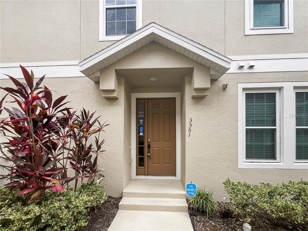 3561 Clay Brick Road, Unit 47A Harmony, FL 34773 - Photo 1 of 1 a front view of a house with a yard and flowers