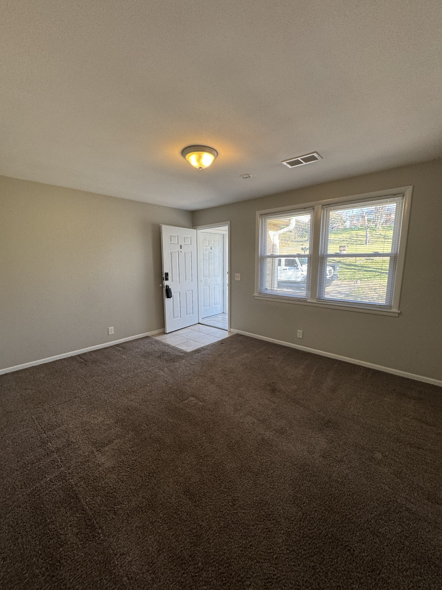 929 Allen Road, Unit B Nashville, TN 37214 - Photo 4 of 7 a view of an empty room with a window