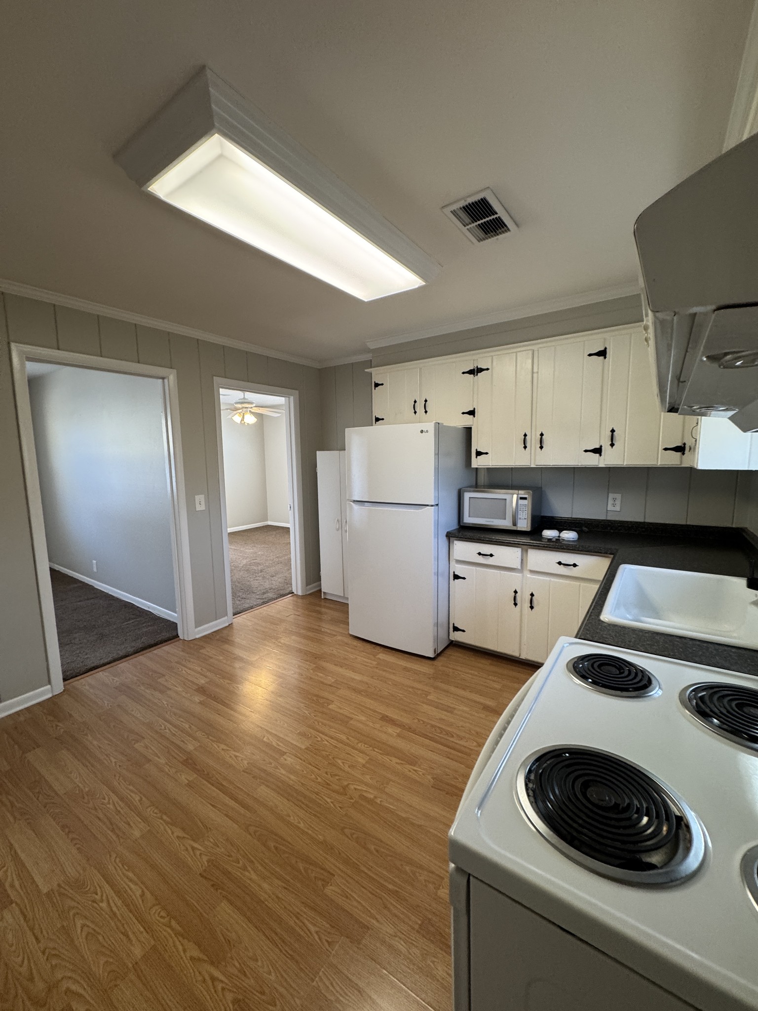 929 Allen Road, Unit B Nashville, TN 37214 - Photo 6 of 7 a kitchen with a sink a stove and refrigerator